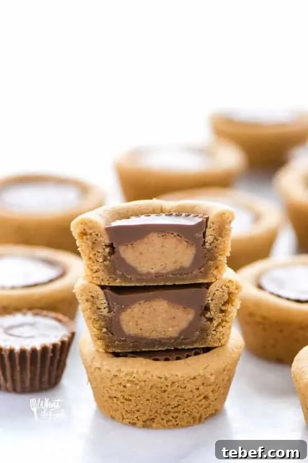 Gluten Free Reese’s Peanut Butter Cookie Cups are a chocolate + peanut butter lovers’ dream cookie! They’re peanut butter cookies baked in mini muffin tins then stuffed with peanut butter cups. Simply amazing! SUPER EASY cookie recipe to make too! Recipe from @whattheforkblog | whattheforkfoodblog.com | gluten free cookie recipes | easy dessert recipes | homemade peanut butter cookies | how to make peanut butter cookies | #glutenfree #chocolate #peanutbutter #cookies #dessert #easyrecipes