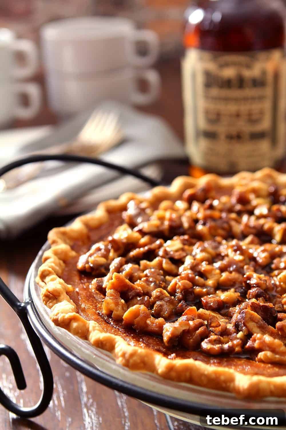 Bourbon Pumpkin Pie with Toasted Walnut Crumble 2 Boubon and Pumpkin Pie with Walnuts in a black metal pie server.