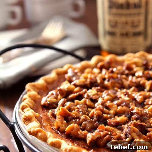 Bourbon Pumpkin Pie with Toasted Walnut Crumble 6 Boubon and Pumpkin Pie with Walnuts in a black metal pie server.
