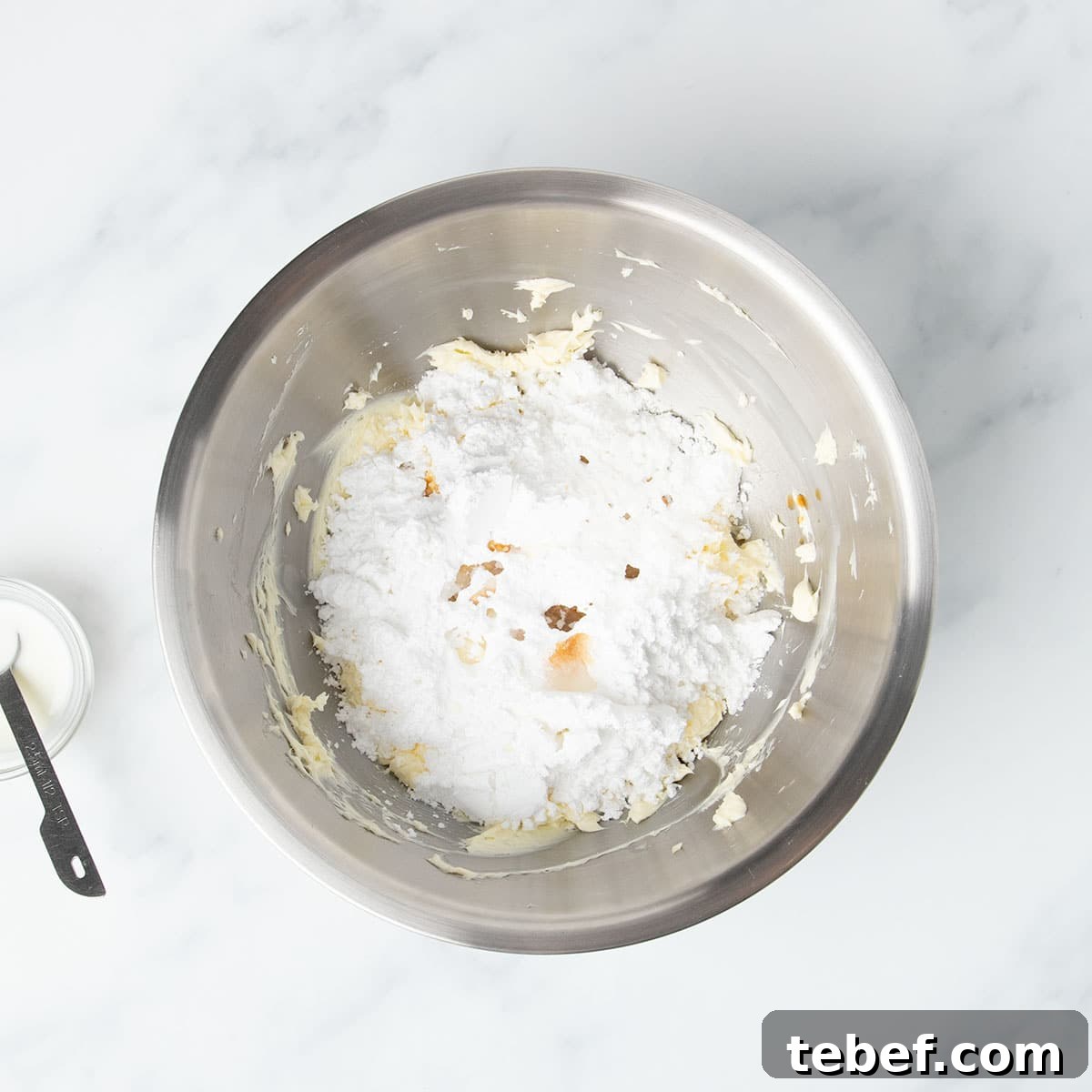 Gluten-Free Vanilla Cupcakes Recipe for Moist, Fluffy Results 21 same mixing bowl with confectioners' sugar, vanilla and some milk on top