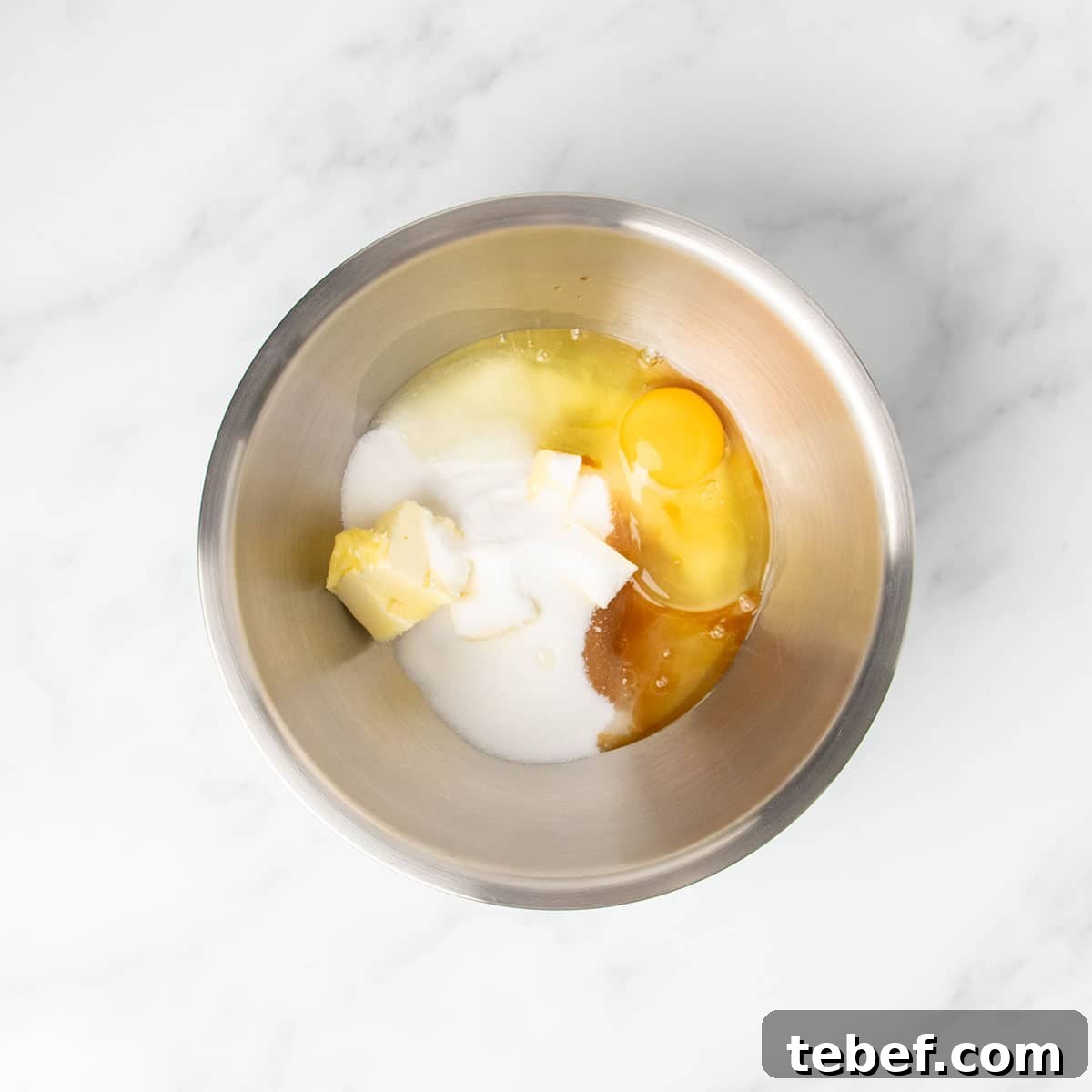 Gluten-Free Vanilla Cupcakes Recipe for Moist, Fluffy Results 7 large round metal mixing bowl with butter, white sugar, vanilla, and egg