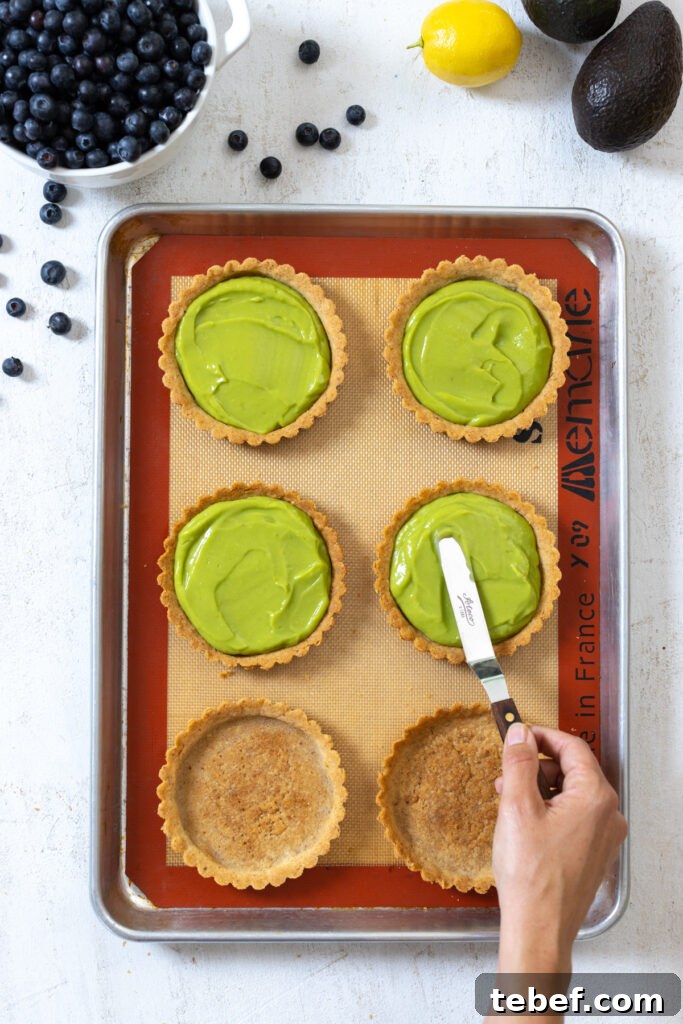 Smoothing avocado filling in almond tart shells