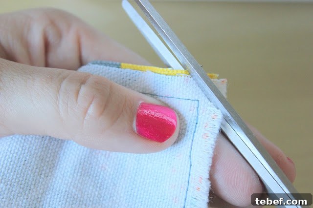 scissors cutting corner of fabric