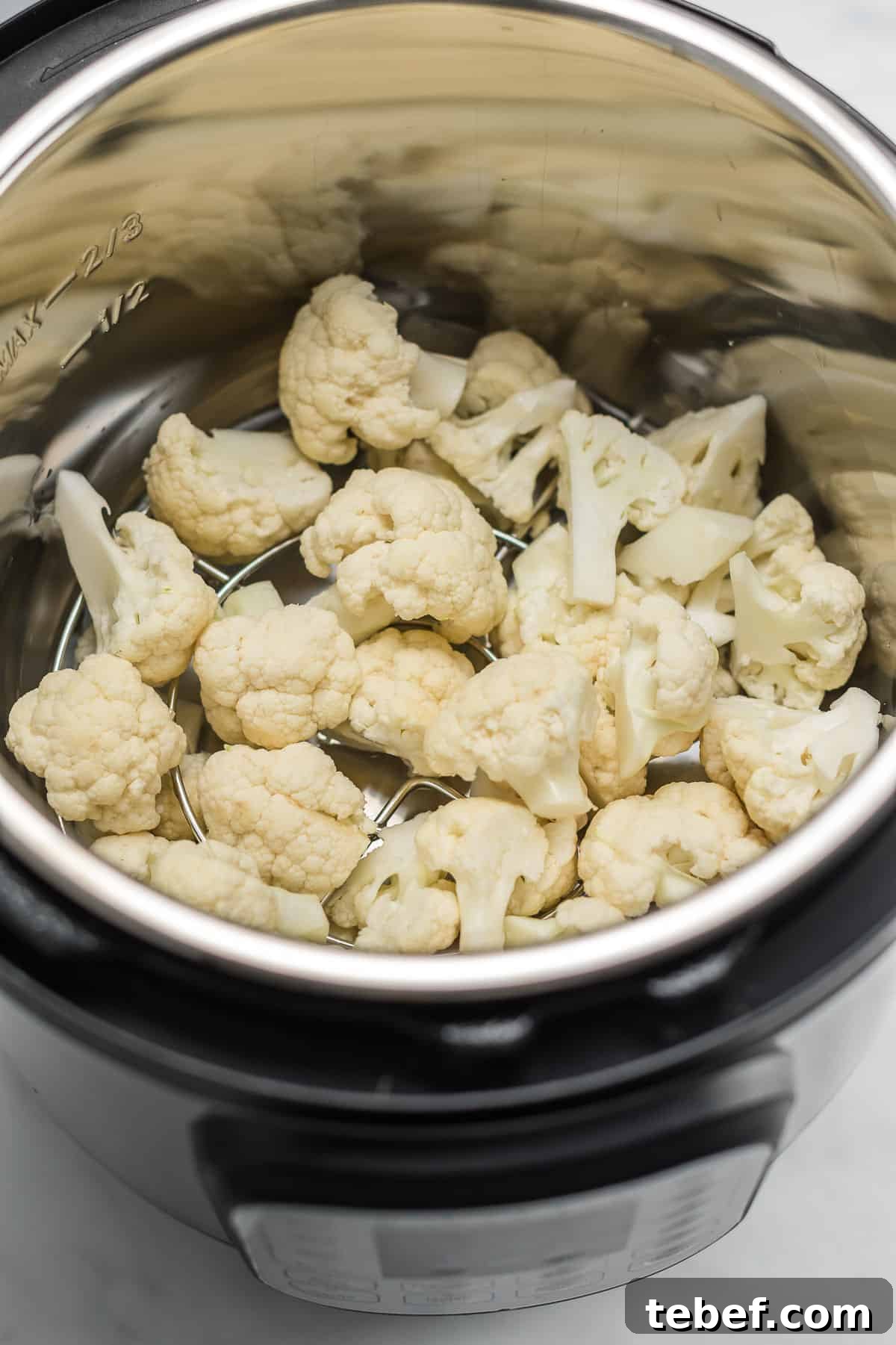 raw cauliflower florets inside an instant pot