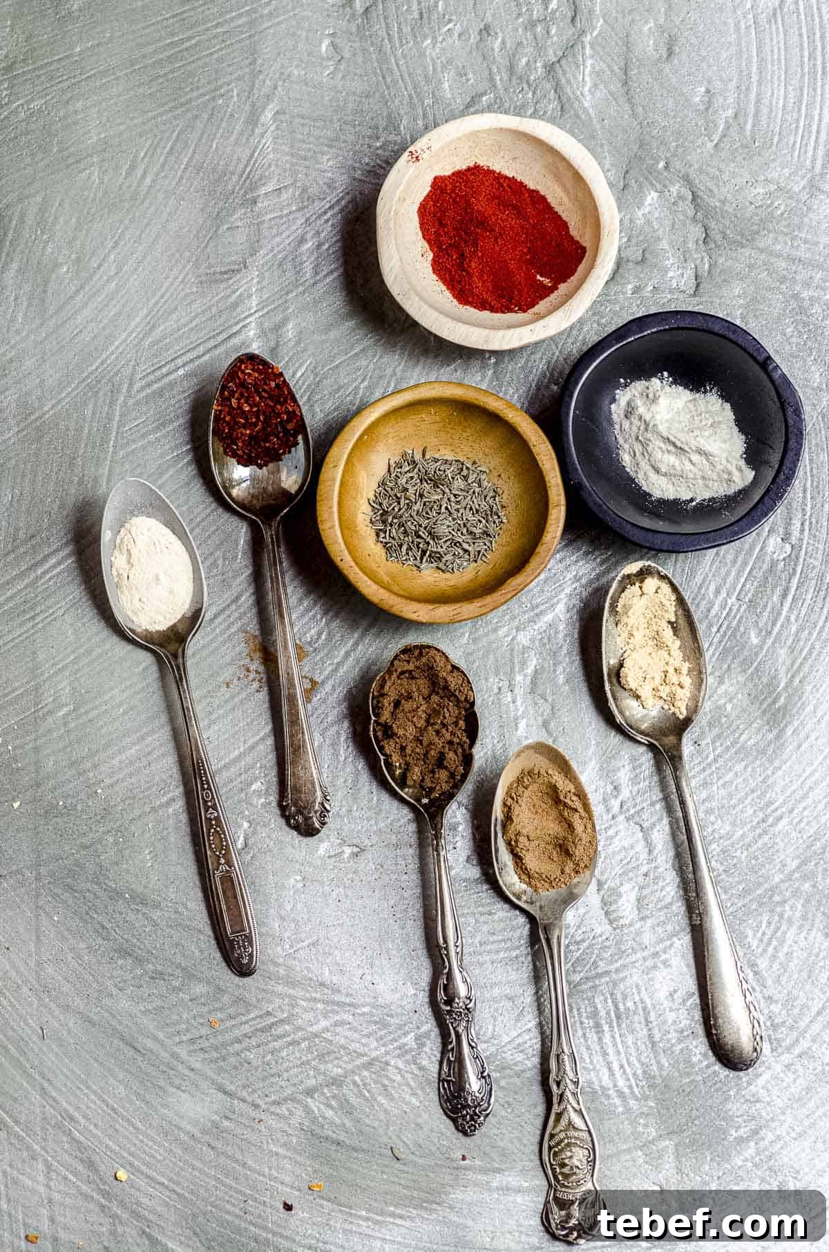 Authentic Jamaican Jerk Seasoning Recipe & Homemade Spice Blend 2 Overhead view of 3 small bowl with spices and some small spoons with spices