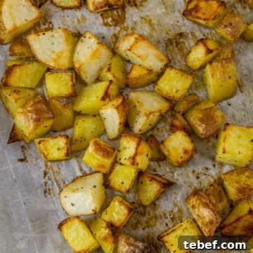 Crispy Sheet-Pan Roasted Potatoes with Garlic and Herbs 3 Sheet Pan Roasted Potatoes on a parchment paper