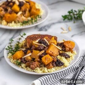 Plates of Moroccan-style chicken with couscous and squash.