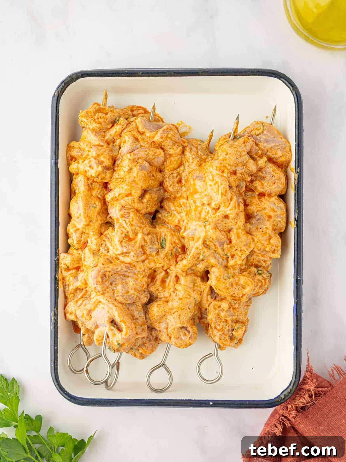 Juicy Oven-Baked Chicken Skewers: Simple Weeknight Recipe 7 Marinated chicken skewers on a tray.