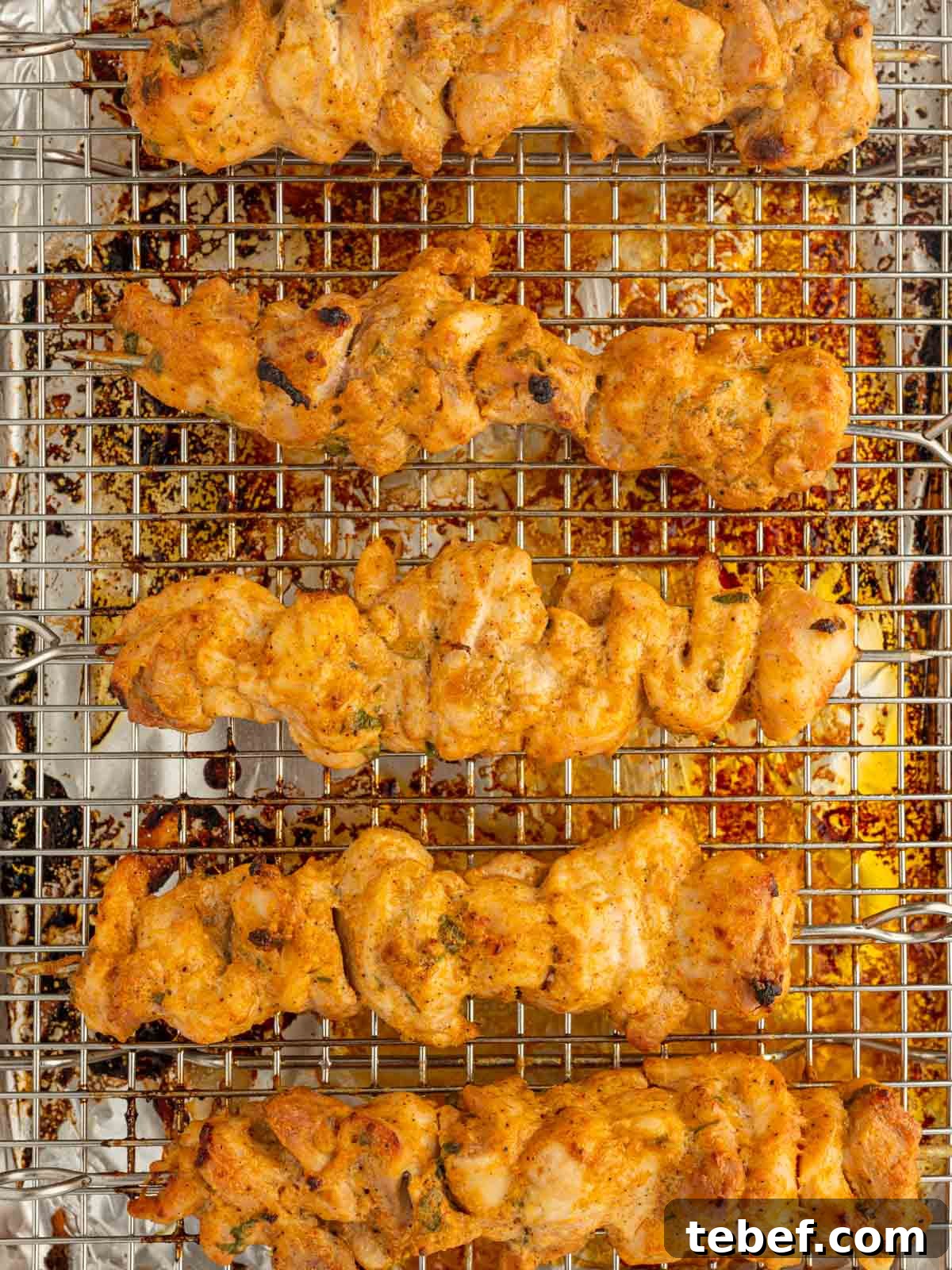 Juicy Oven-Baked Chicken Skewers: Simple Weeknight Recipe 8 Baking chicken skewers on a tray.