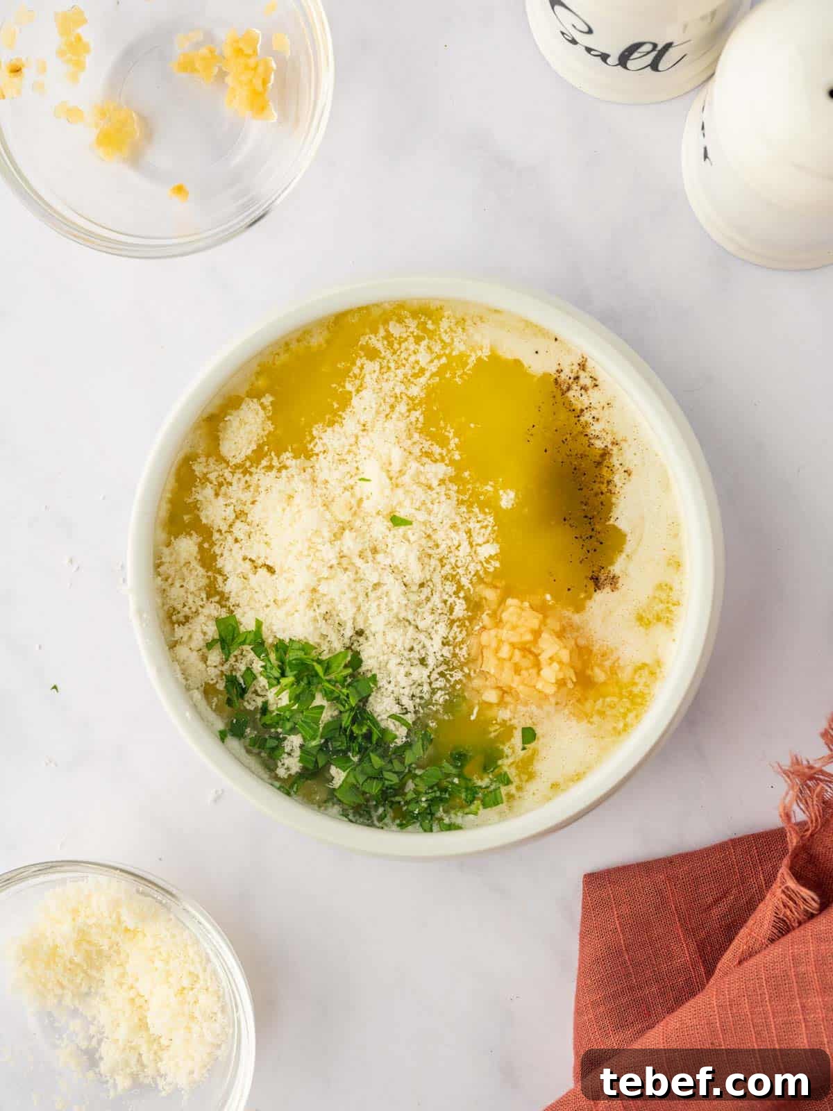 Juicy Oven-Baked Chicken Skewers: Simple Weeknight Recipe 9 Parmesan butter sauce being mixed in a bowl.