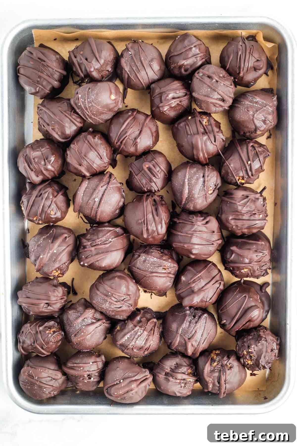 Chocolate-Dipped Matzo Crack Balls: Crispy Sweet Snack Recipe 2 Chocolate balls with chocolate drizzle.