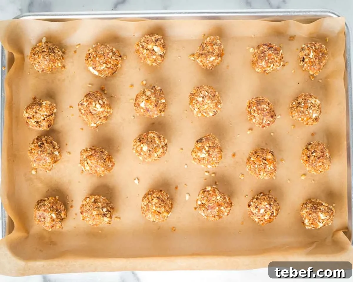 Chocolate-Dipped Matzo Crack Balls: Crispy Sweet Snack Recipe 9 Parchment lined baking sheet with golf ball sized matzo mixture.