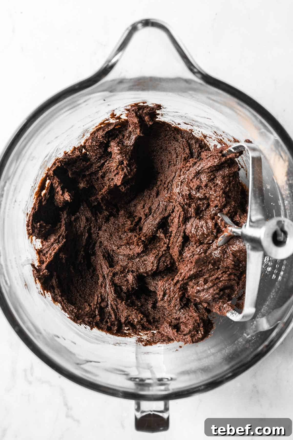 Chocolate mascarpone cookie dough in a glass mixing bowl.