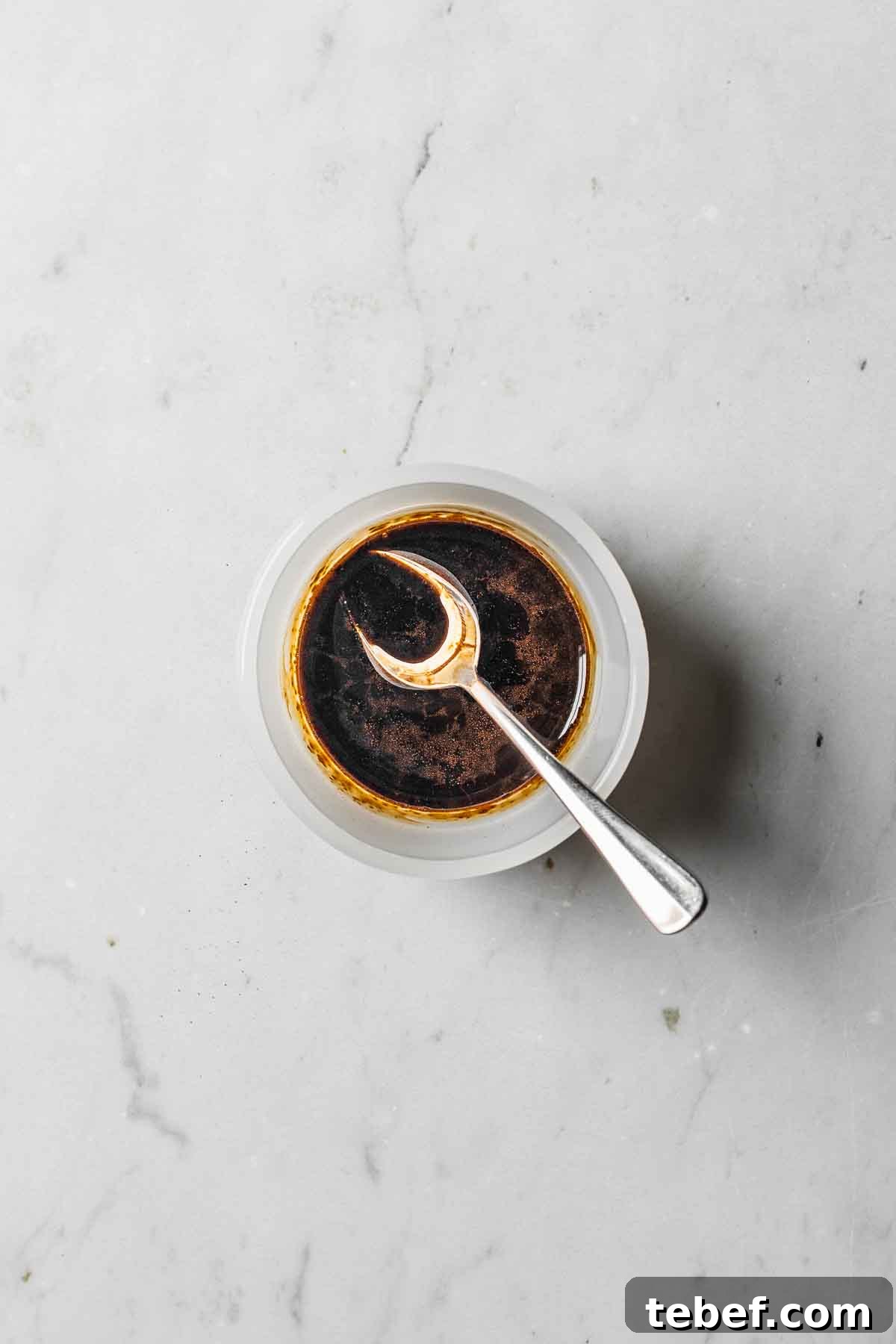 Espresso powder and vanilla extract mixed together in a small bowl.
