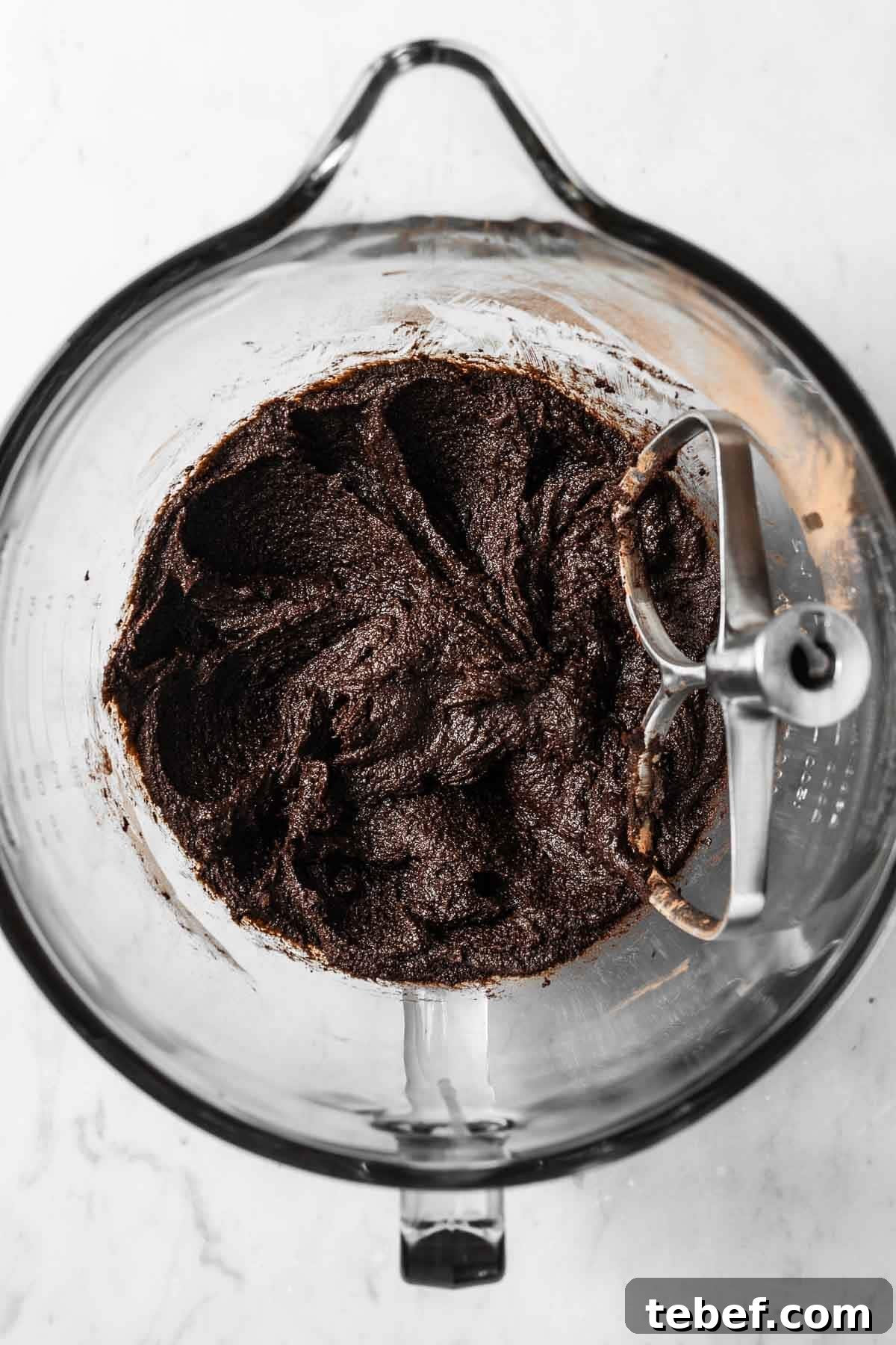 Melted butter, brown sugar and cocoa powder in a glass mixing bowl.