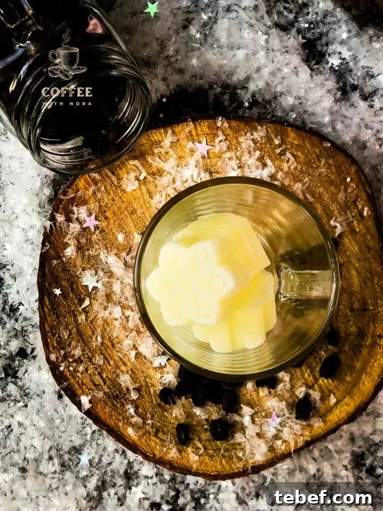 Creamy Iced Coffee with Milk Recipe: Chilled Cafe-Style Drink 3 View from above: Glass filled with frozen milk ice cubes.