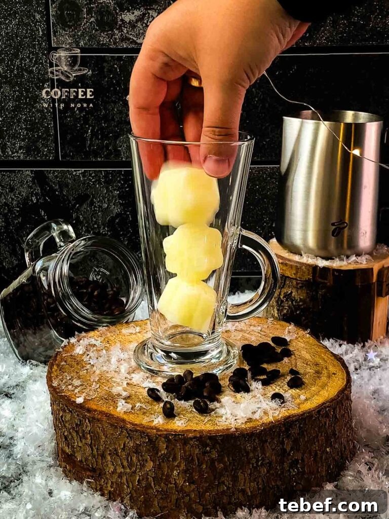 Creamy Iced Coffee with Milk Recipe: Chilled Cafe-Style Drink 4 Glass filled with frozen milk ice cubes.