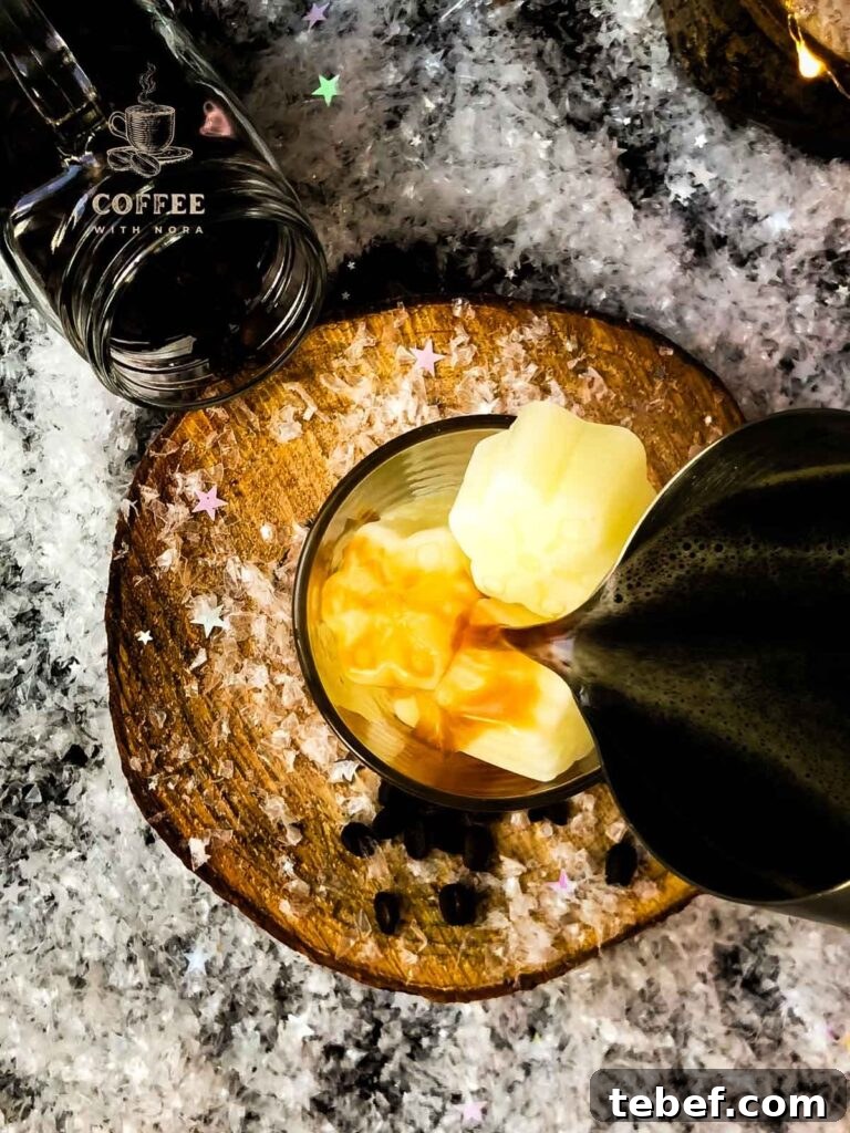 Creamy Iced Coffee with Milk Recipe: Chilled Cafe-Style Drink 5 View from above: Fill the glass filled with frozen milk ice cubes with coffee.
