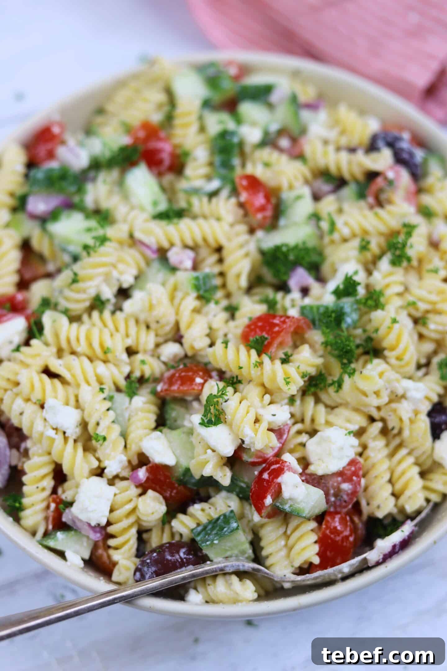Classic Greek Pasta Salad Recipe for Mediterranean Flavor 5 A close up of pasta salad with a Greek style dressing.