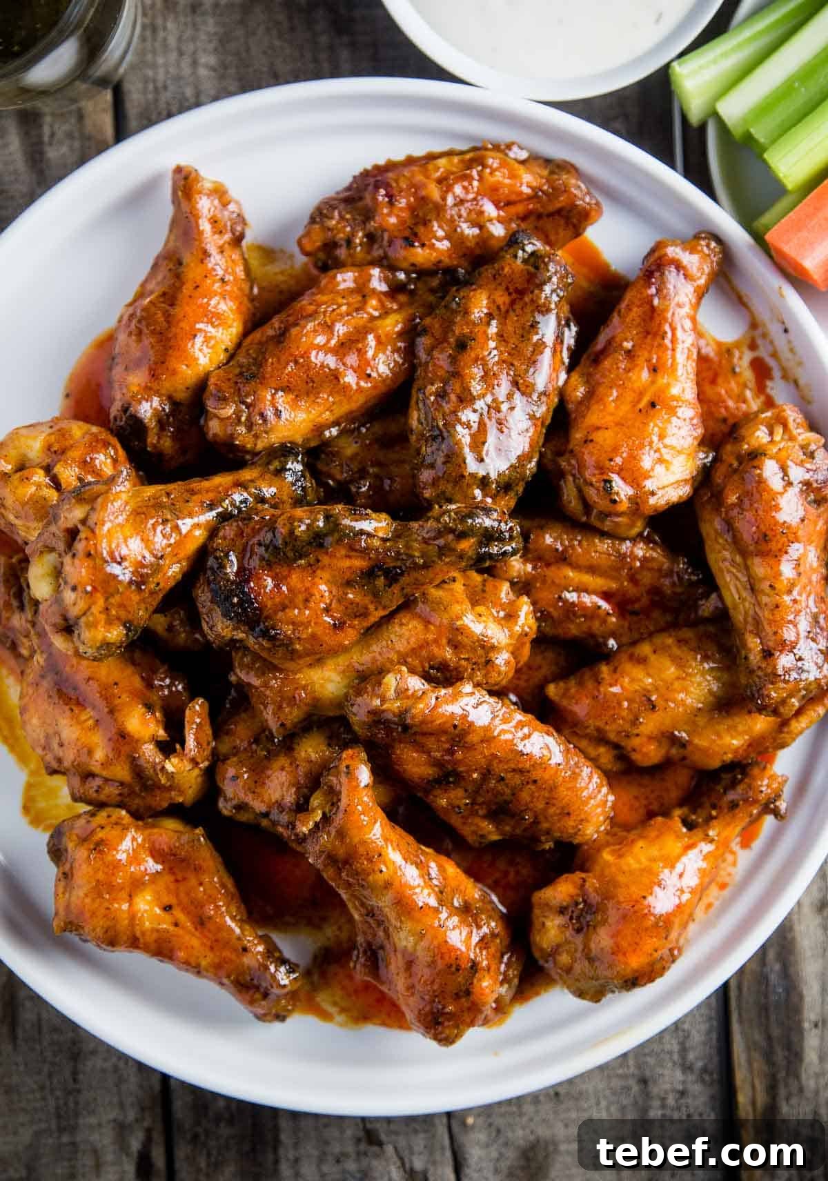 How to Cut Whole Chicken Wings Into Flats and Drumettes for Perfect Portions 2 Smoked buffalo chicken wings on a plate with sauce and ranch.