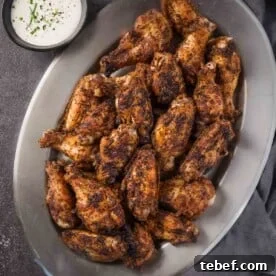 How to Cut Whole Chicken Wings Into Flats and Drumettes for Perfect Portions 13 Dry Rub Chicken Wings on a platter next to a bowl of homemade ranch dressing