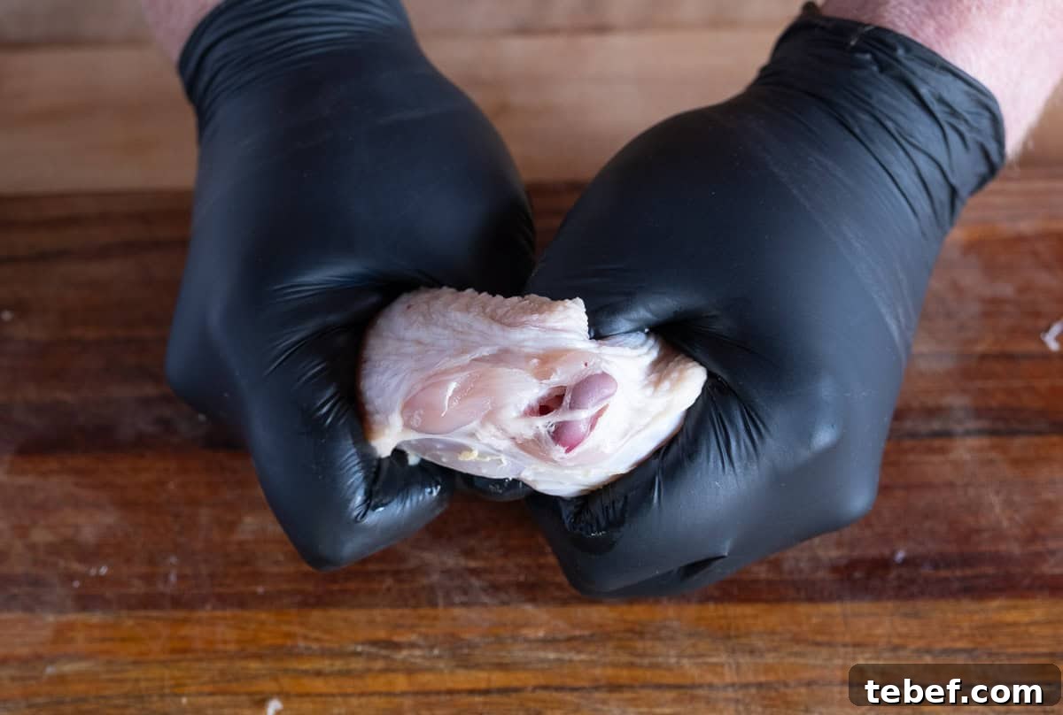 How to Cut Whole Chicken Wings Into Flats and Drumettes for Perfect Portions 7 Separating drums and flats of a whole chicken wing step 3.