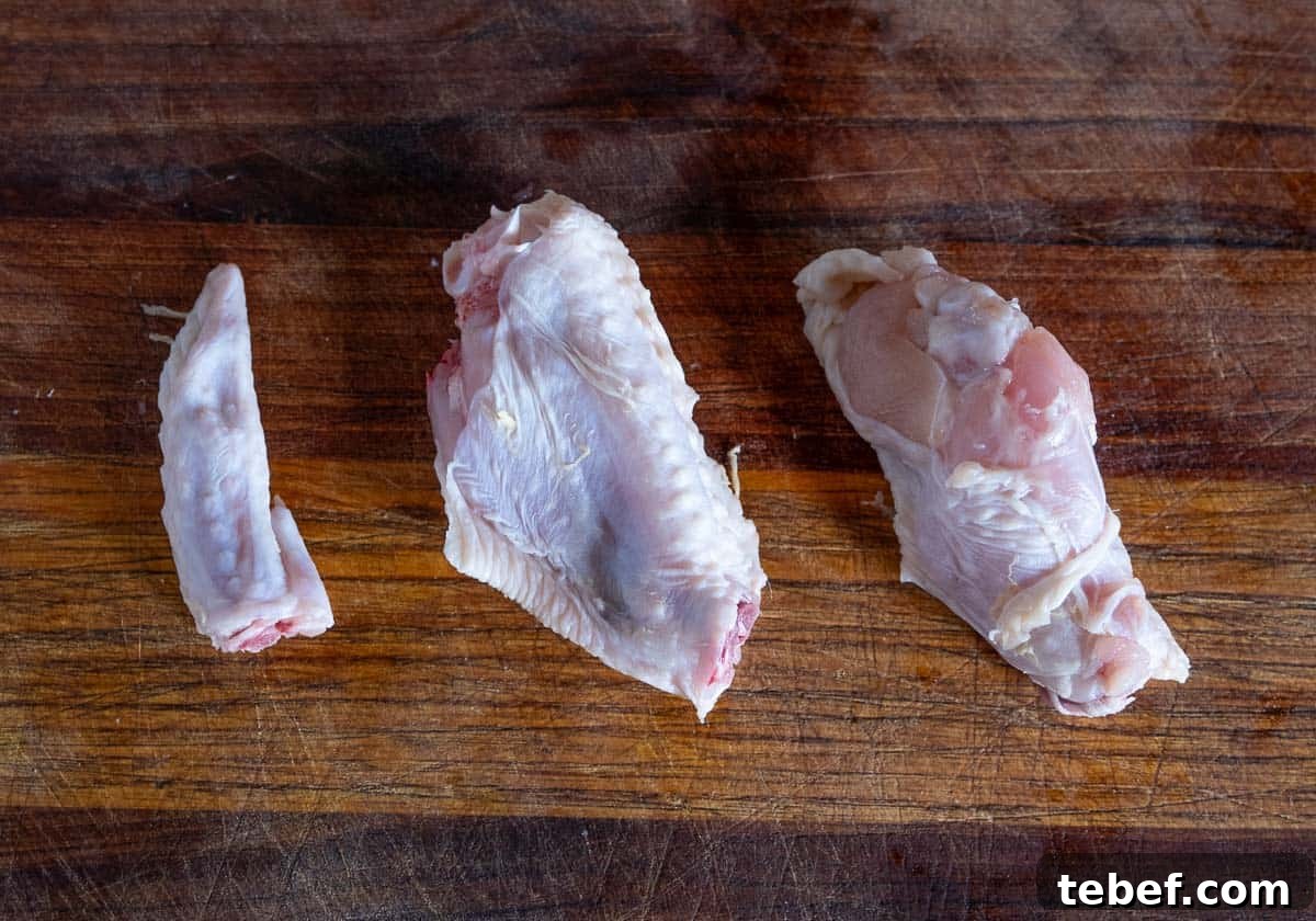 How to Cut Whole Chicken Wings Into Flats and Drumettes for Perfect Portions 10 A whole chicken wing, separated into three parts - the drum, the flat, and the winglet.