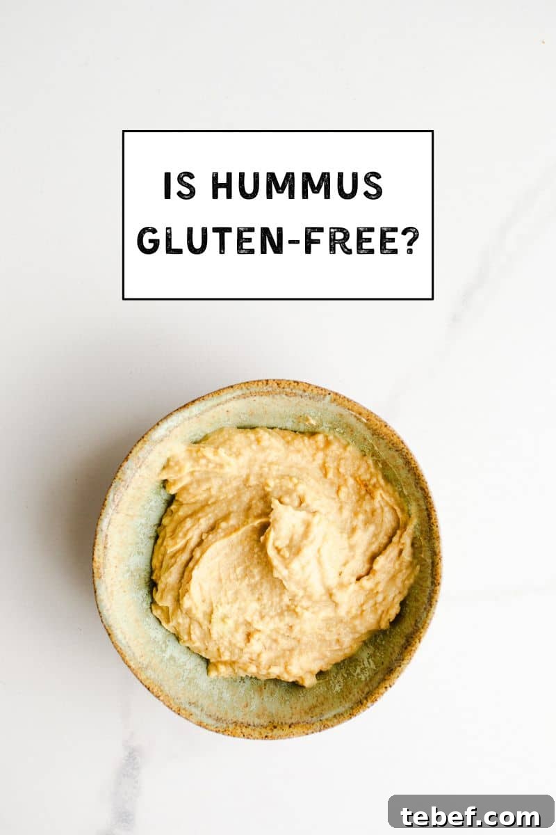 Is Hummus Gluten Free? What to Know About Ingredients & Safety 2 Hummus in a small green bowl.