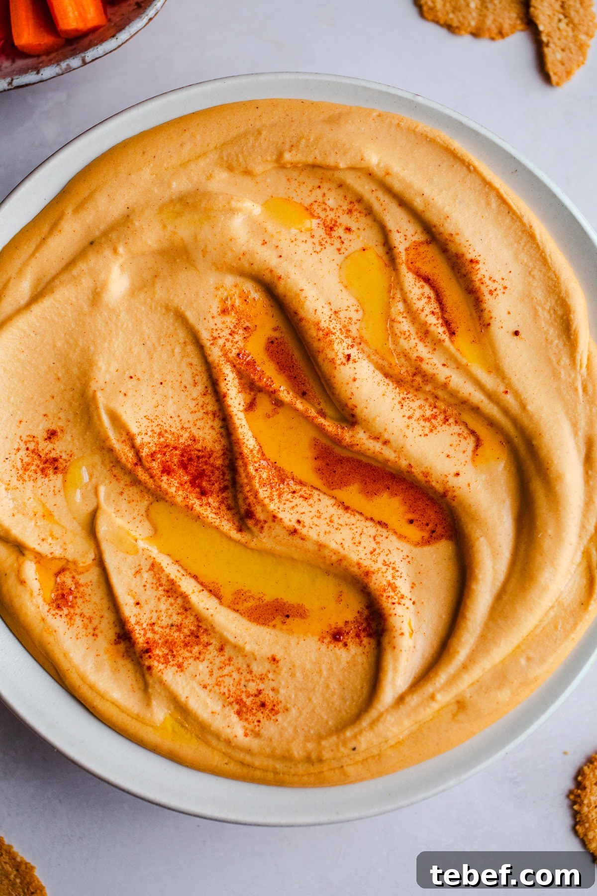 Is Hummus Gluten Free? What to Know About Ingredients & Safety 3 Red hummus in a white bowl.