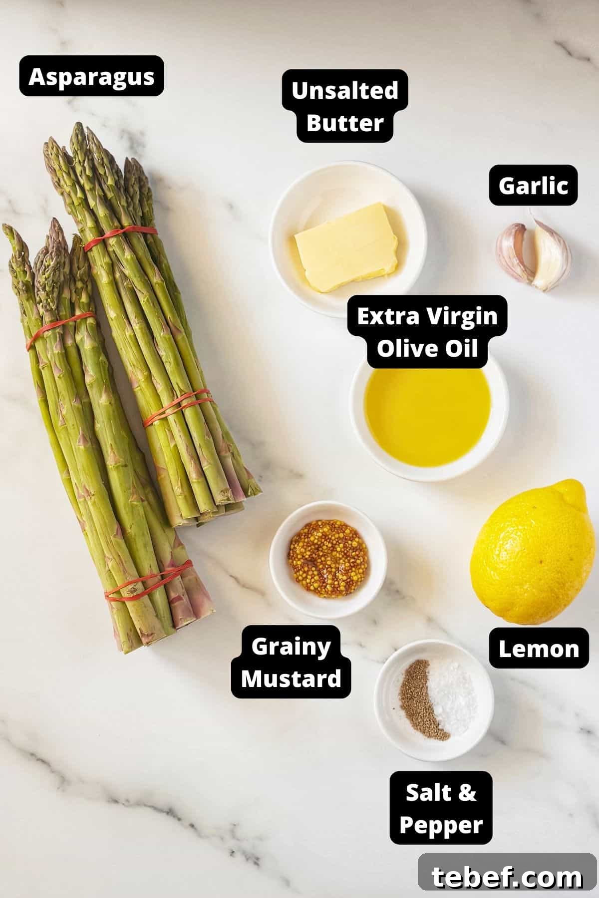 Crispy Garlic Sautéed Asparagus Recipe 3 Ingredients in this recipe on a white marble background.