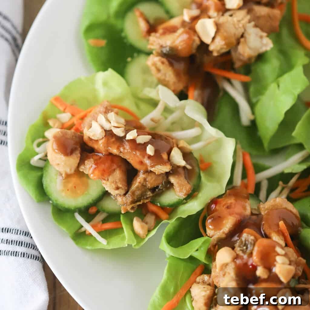Creamy Thai Peanut Sauce Recipe for Dipping & Stir-Fries 5 Lettuce wraps filled with chicken, sliced veggies, and topped with Thai peanut sauce.