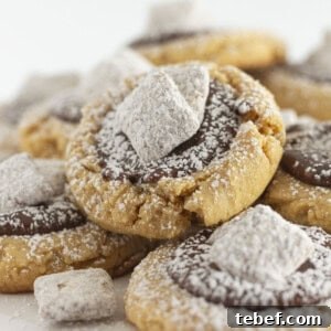 Muddy Buddy Cookies on a white cake plate.