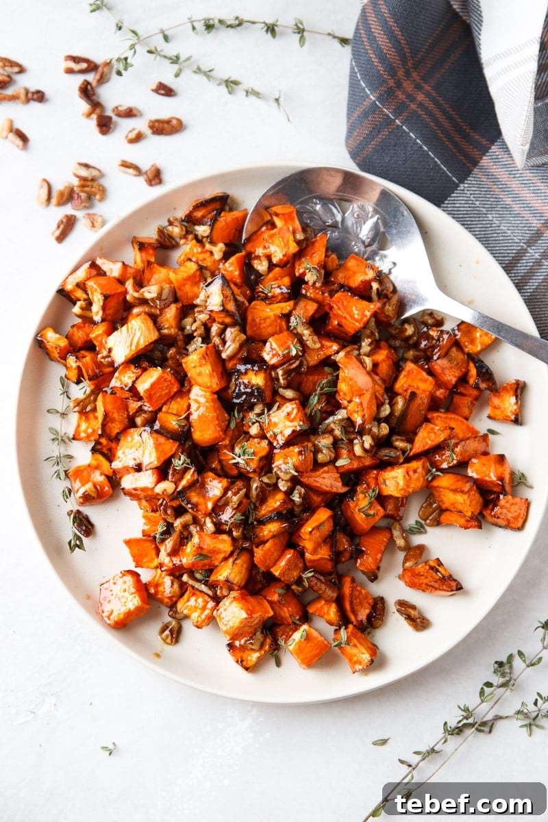 Maple Pecan Sweet Potatoes in the Air Fryer: Crispy & Caramelized 11 Cooked maple sweet potatoes with pecans and fresh thyme, silver spoon, plaid cloth.