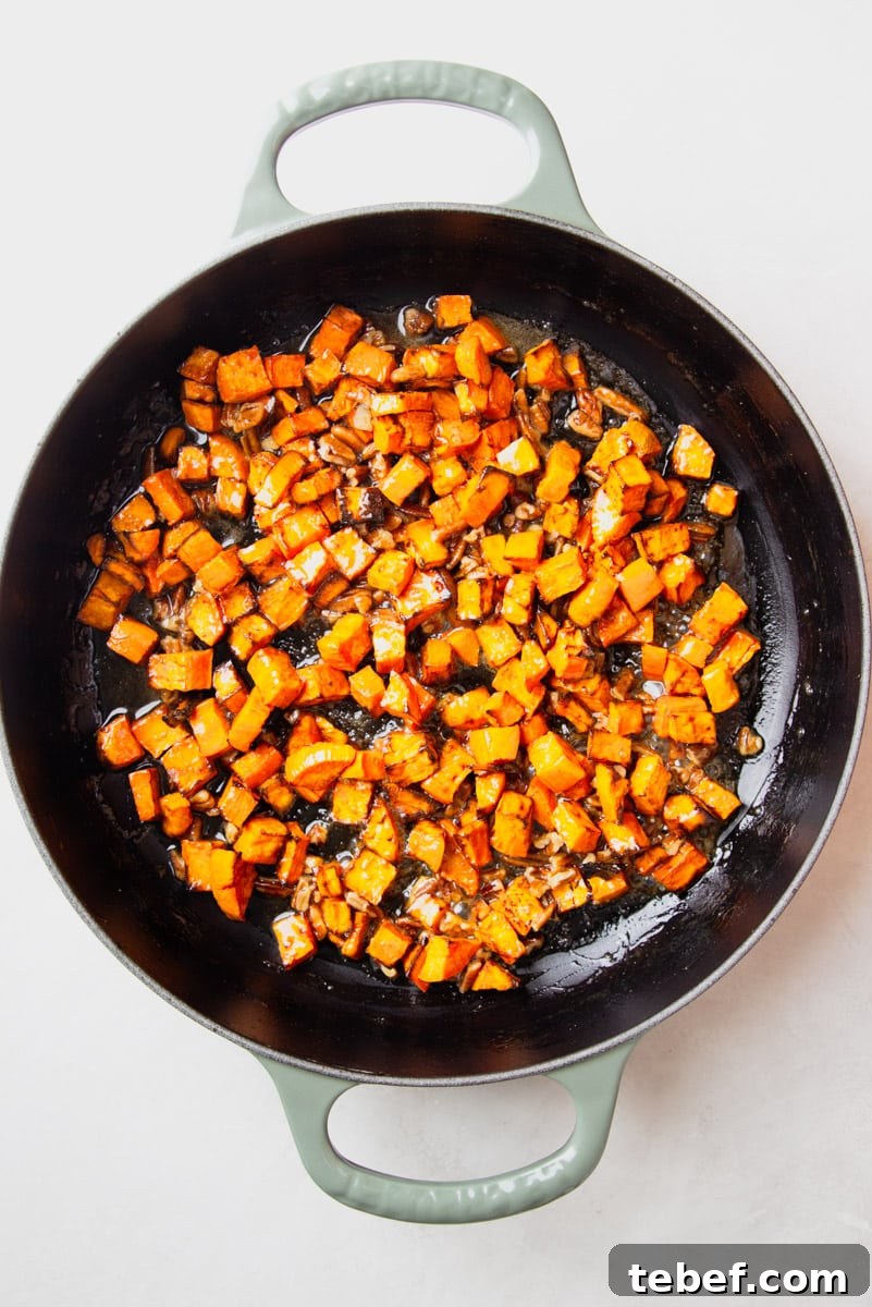 Maple Pecan Sweet Potatoes in the Air Fryer: Crispy & Caramelized 8 Diced sweet potatoes in a skillet.