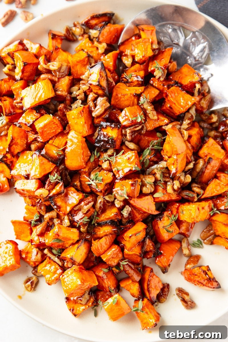 Maple Pecan Sweet Potatoes in the Air Fryer: Crispy & Caramelized 10 Cooked maple sweet potatoes with pecans and fresh thyme, silver spoon, plaid cloth.