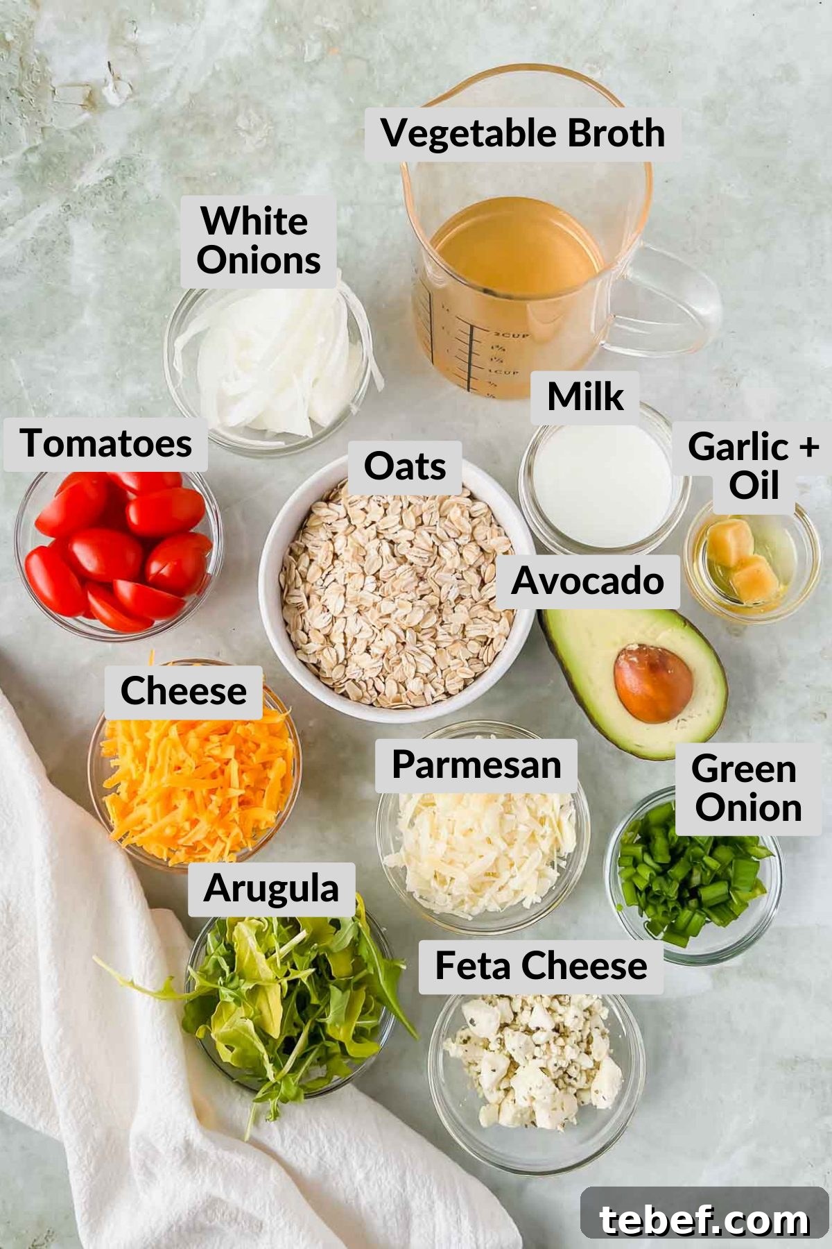 Savory Cheesy Oatmeal Recipe: Comforting Savory Oats in 15 Minutes 3 ingredients for cheesy oatmeal in individual bowls on gray slate background.