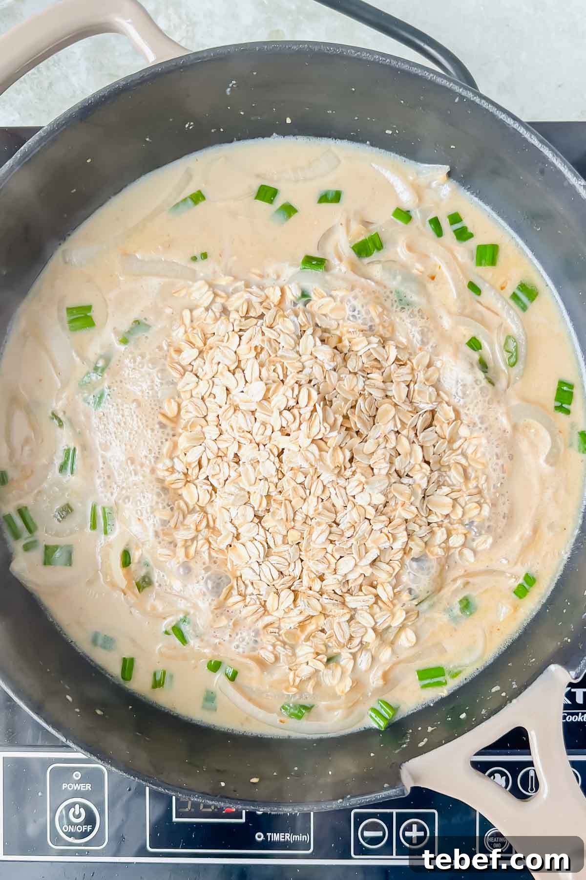 Savory Cheesy Oatmeal Recipe: Comforting Savory Oats in 15 Minutes 7 old fashioned oats added to skillet and liquid mixture.