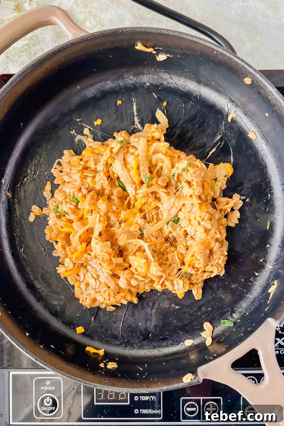 Savory Cheesy Oatmeal Recipe: Comforting Savory Oats in 15 Minutes 8 cooked cheesy oatmeal on a skillet, ready to be plated.