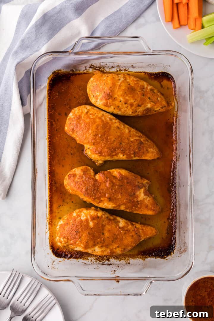 Oven-Baked Buffalo Chicken Thighs with Crispy Skin 2 Baked Buffalo Chicken in baking dish.