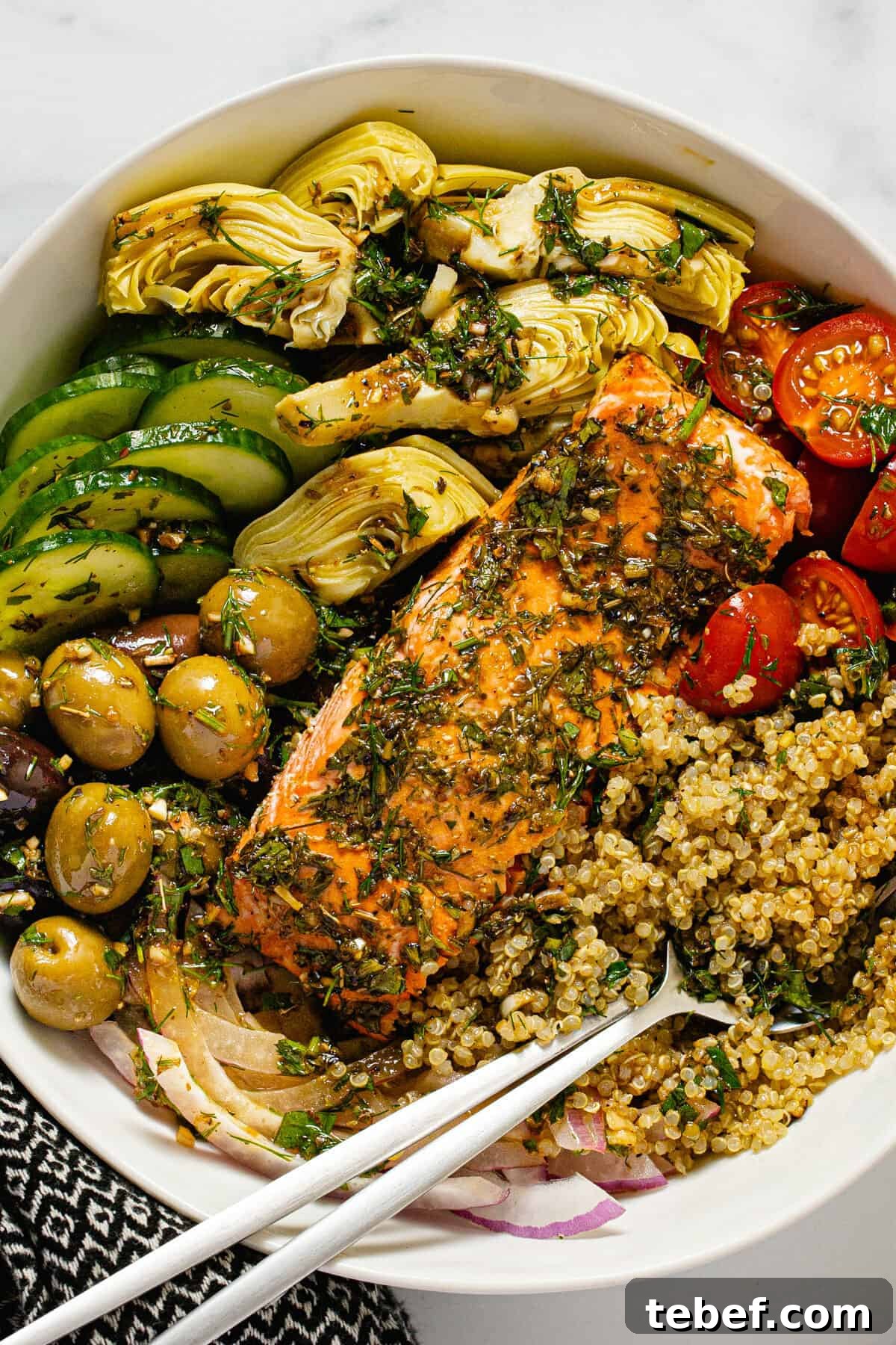 Greek Salmon Bowl Recipe with Lemon-Dill Yogurt Dressing 7 Large white bowl filled with Mediterranean salmon veggies and quinoa