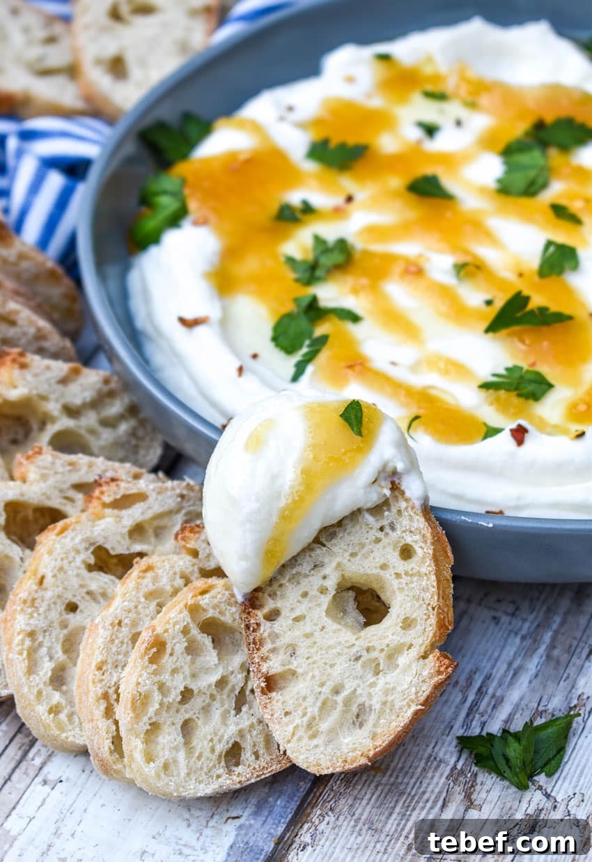 a baguette sliced topped with whipped ricotta cheese dip spread