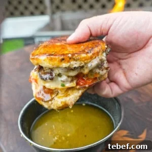 Pizza Smashburger Recipe: Crispy Beef Patty with Melty Pizza Toppings 16 Dipping the pizza smashburger in garlic Parmesan butter