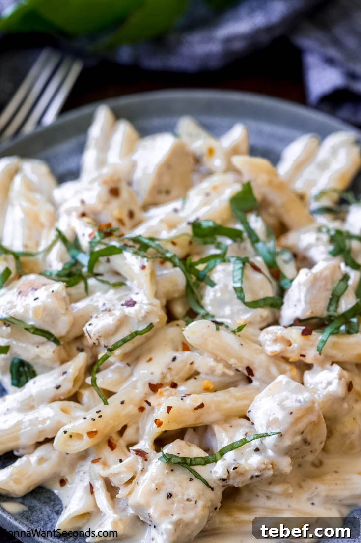 This creamy lemon chicken pasta is a comfort food your whole family will adore. Pasta and chunks of chicken in a rich, velvety, luscious lemony cream sauce! lemon chicken pasta on a plate, close shot