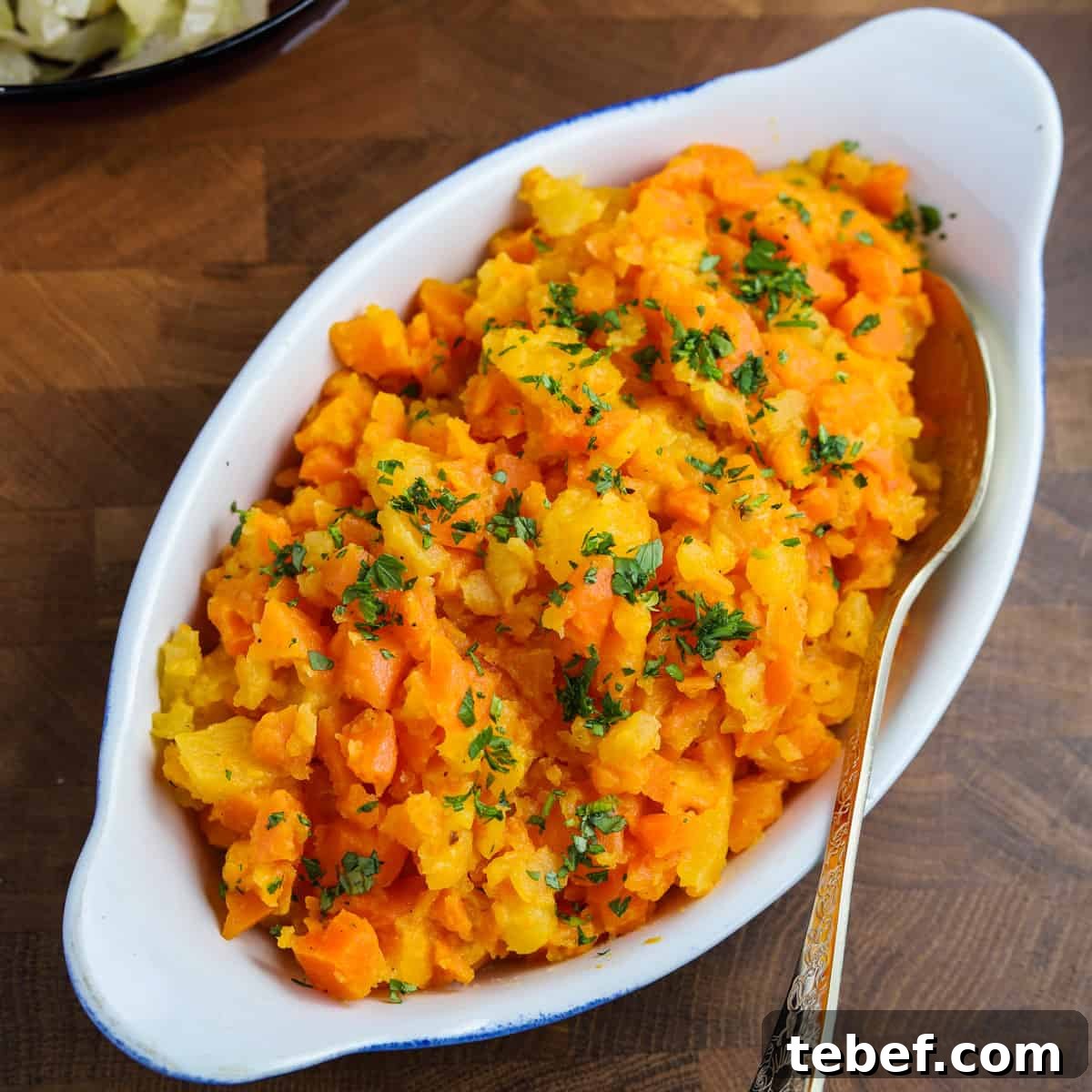 Photo of a dish of chopped carrot & swede.