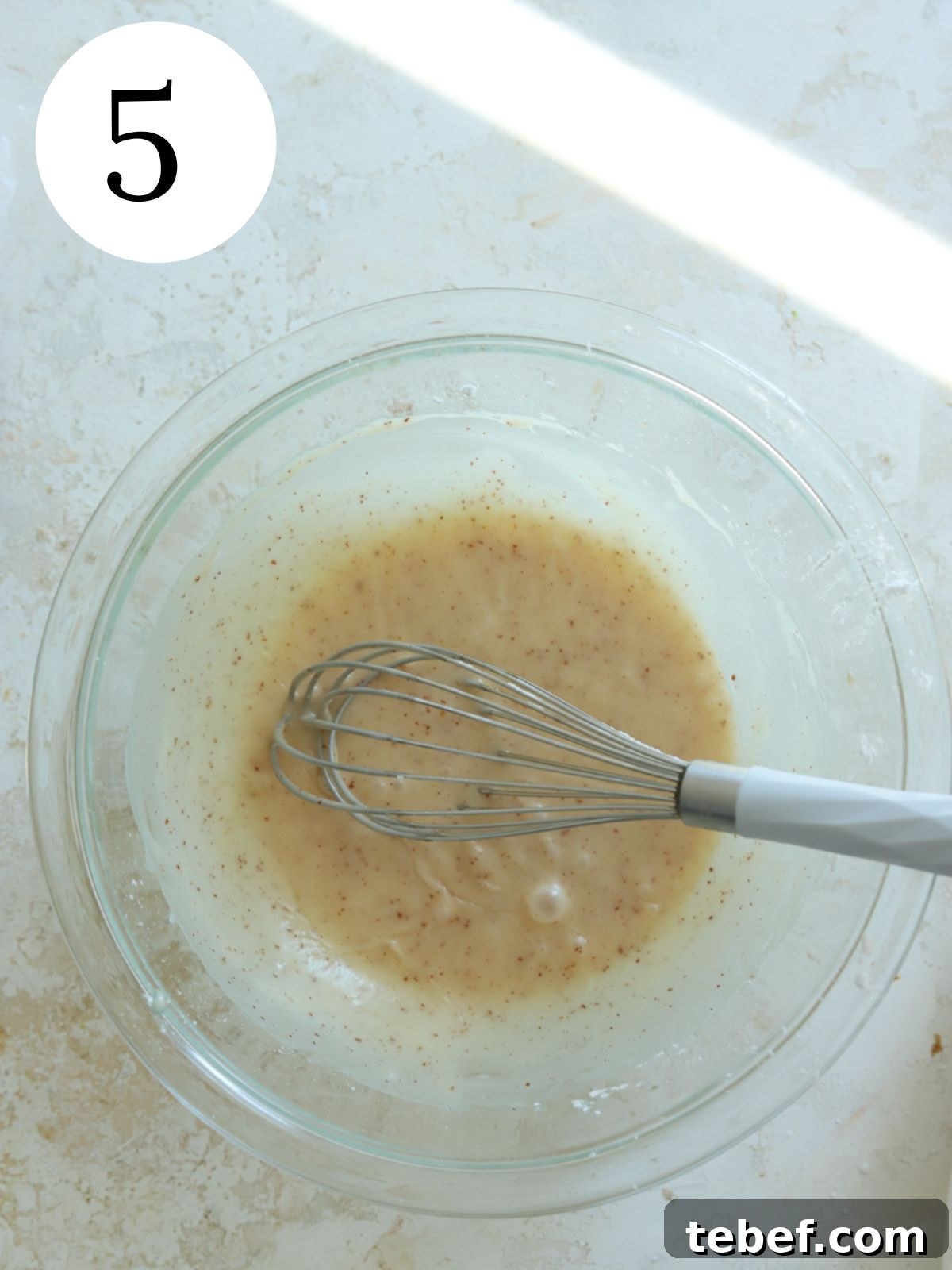 Moist Banana Olive Oil Cake Recipe for Perfect Homemade Dessert 8 Brown butter glaze in a glass bowl with a whisk.