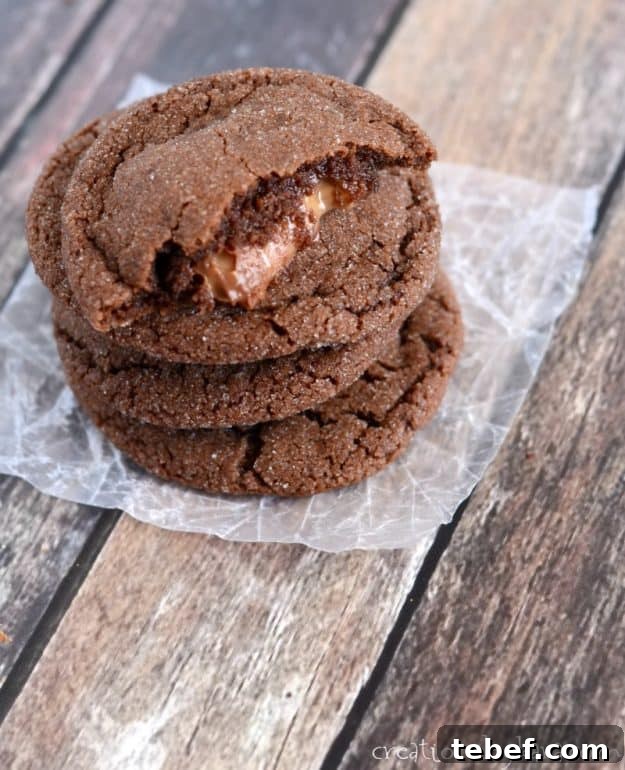 Chewy chocolate cookies with a caramel filling. These Rolo Cookies are hard to beat! #rolocookies #caramelfilledcookies #chocolatecaramelcookies - from creationsbykara.com stack of chocolate cookies filled with rolos