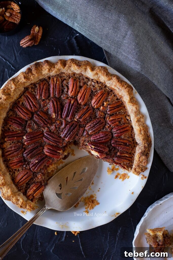 Top down view of the maple syrup pecan pie with a quarter removed.