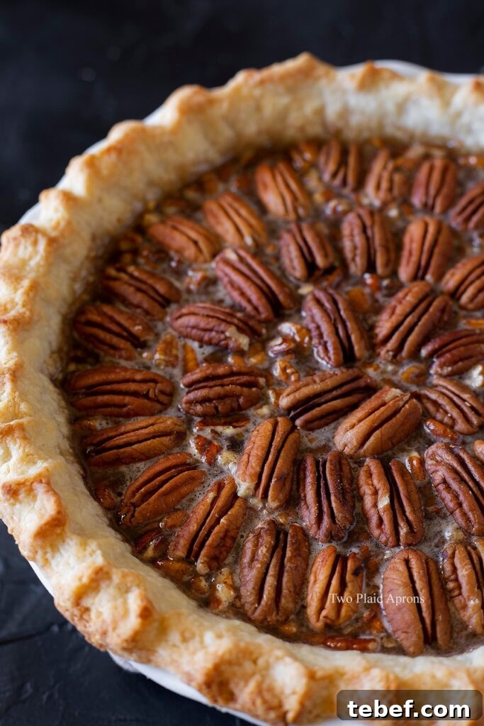 Angled view of the maple syrup pecan pie before baking.