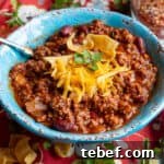 Chili served with grated cheddar cheese.