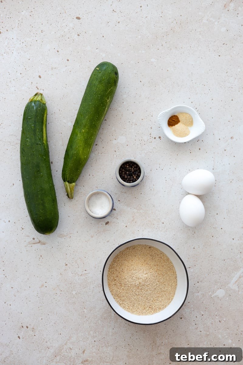 Ingredients for baked zucchini slices in small bowls. 